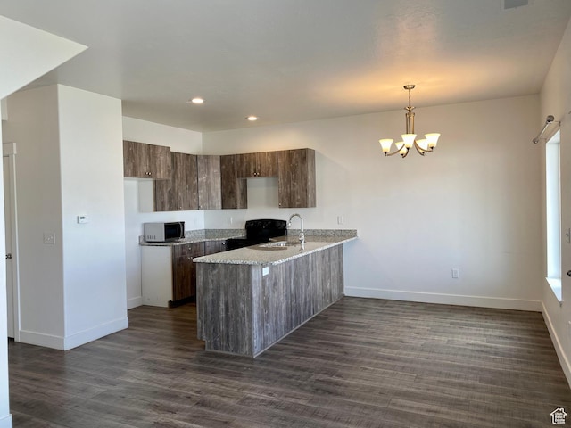 22 E Cedar Ln, Malad City, ID 83252 - kitchen with a peninsula, a sink, baseboards, dark wood-style floors, and recessed lighting