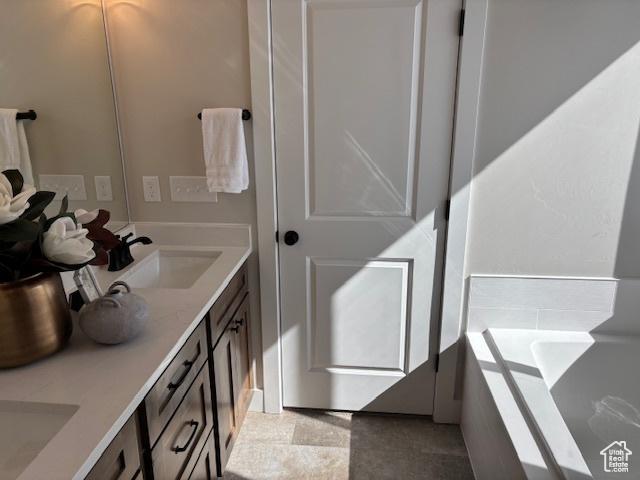584 N 510 E, Smithfield, UT 84335 - full bathroom featuring a sink, a washtub, and double vanity