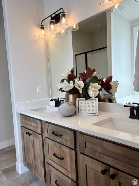 584 N 510 E, Smithfield, UT 84335 - full bathroom with double vanity, baseboards, a sink, and a stall shower