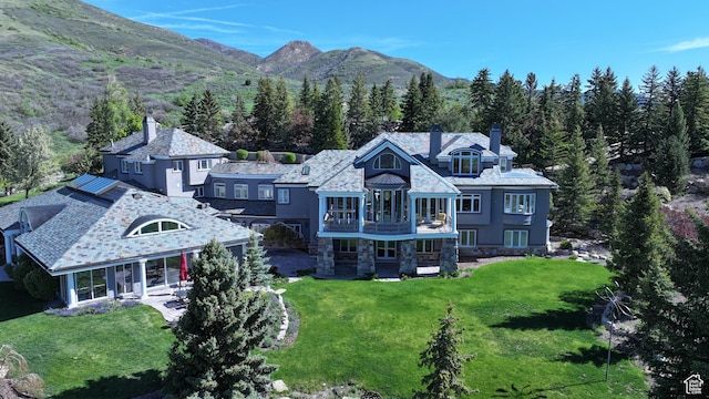 5678 E Twin Creek Rd, Emigration Canyon, UT 84108 - back of property featuring a chimney, a balcony, a yard, and a forest view