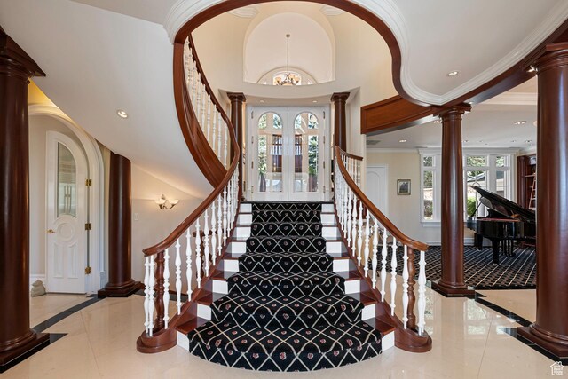5678 E Twin Creek Rd, Emigration Canyon, UT 84108 - stairway with decorative columns, a chandelier, inlaid floor details, ornamental molding, and recessed lighting
