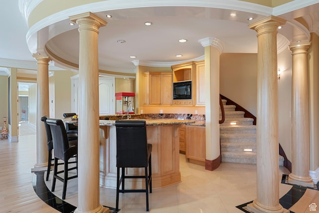 5678 E Twin Creek Rd, Emigration Canyon, UT 84108 - kitchen featuring light brown cabinets, ornate columns, black microwave, a breakfast bar area, and recessed lighting