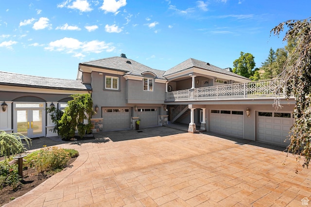 5678 E Twin Creek Rd, Emigration Canyon, UT 84108 - view of front of house with french doors, stucco siding, a garage, stairway, and driveway