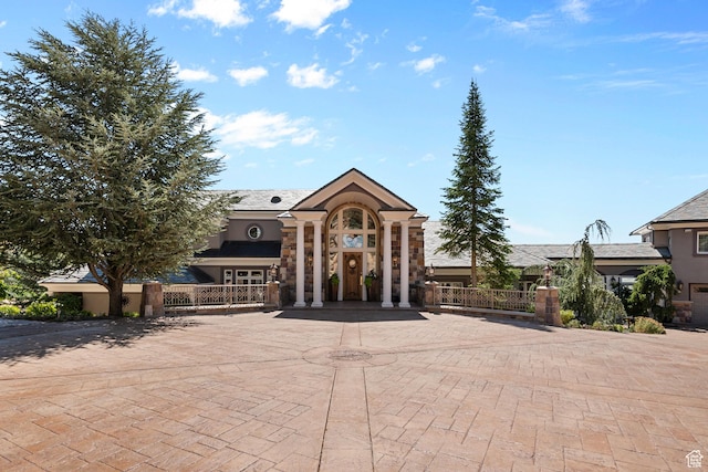 5678 E Twin Creek Rd, Emigration Canyon, UT 84108 - view of front of property featuring stone siding, fence, and stucco siding