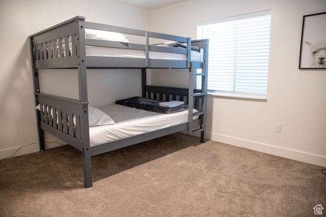 carpeted bedroom with baseboards