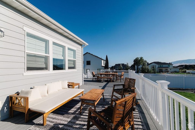 wooden terrace with an outdoor hangout area, outdoor dining area, and fence