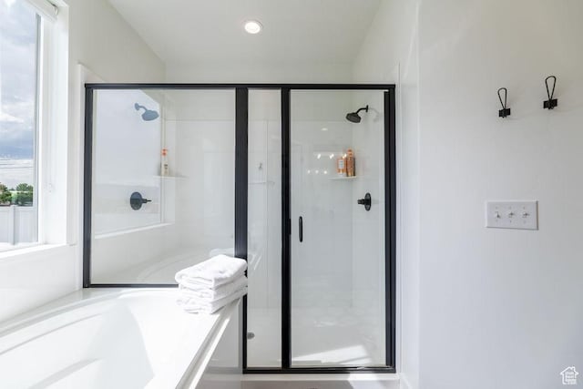 full bathroom featuring a stall shower and a bathtub