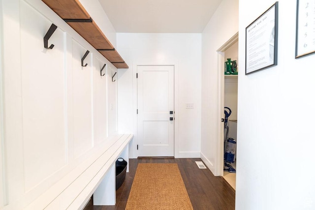 mudroom featuring dark wood finished floors and baseboards