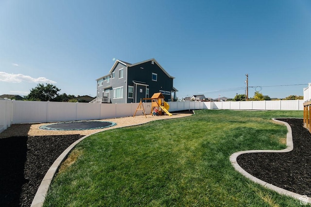 view of yard featuring a fenced backyard and a playground