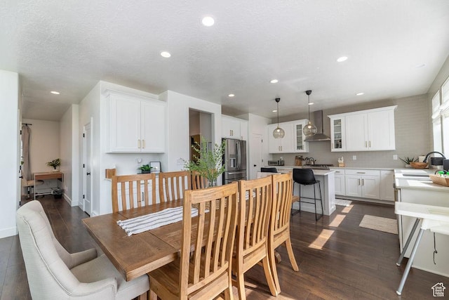 dining space featuring dark wood finished floors, baseboards, recessed lighting, and a textured ceiling