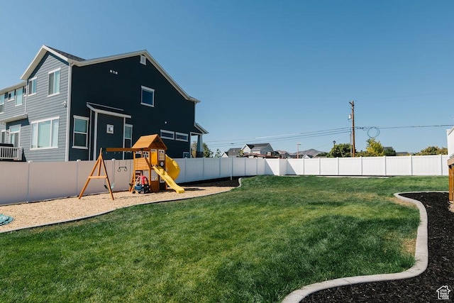 view of yard featuring a fenced backyard and a playground