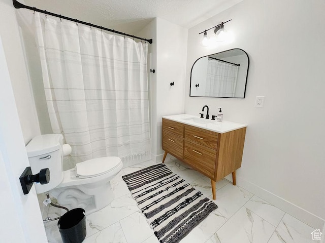 bathroom featuring a textured ceiling, baseboards, marble finish floor, toilet, and vanity
