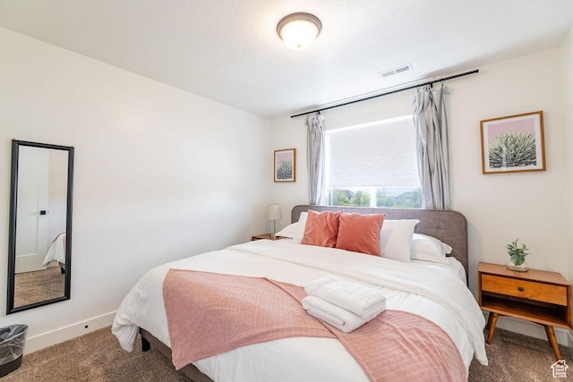 bedroom featuring baseboards, visible vents, and carpet flooring