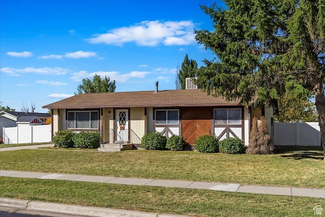 single story home with fence and a front yard