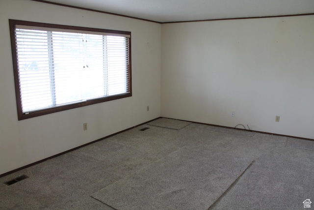 carpeted empty room with baseboards and ornamental molding