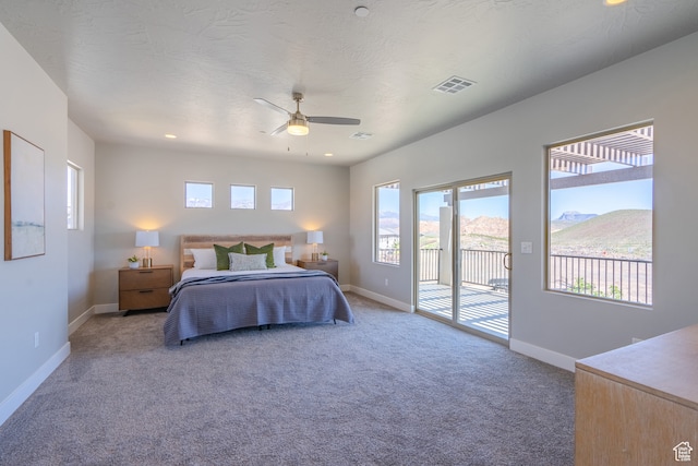 278 N 2020 W, Hurricane, UT 84737 - carpeted bedroom with a mountain view, access to exterior, a textured ceiling, and ceiling fan