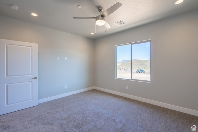 278 N 2020 W, Hurricane, UT 84737 - spare room with a mountain view, carpet floors, a textured ceiling, and ceiling fan
