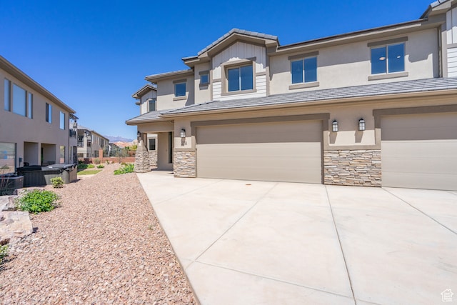 view of front of house featuring central AC and a garage