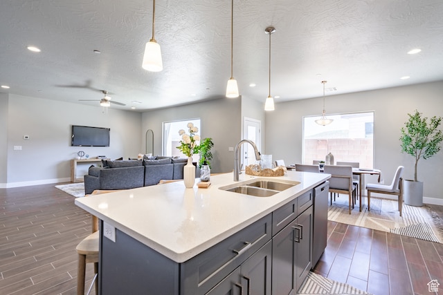 278 N 2020 W, Hurricane, UT 84737 - kitchen with sink, dishwasher, pendant lighting, dark wood-type flooring, and a center island with sink