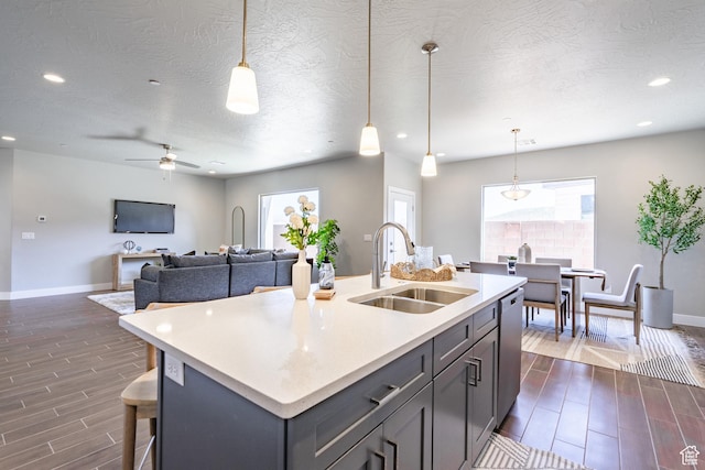 278 N 2020 W, Hurricane, UT 84737 - kitchen with dishwasher, light countertops, wood tiled floors, a ceiling fan, and healthy amount of natural light