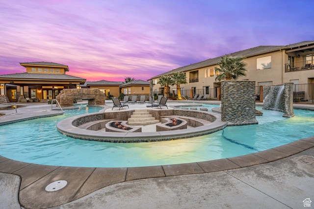 278 N 2020 W, Hurricane, UT 84737 - pool at dusk with a patio, a hot tub, pool water feature, and an outdoor fire pit