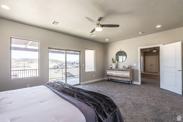 278 N 2020 W, Hurricane, UT 84737 - bedroom featuring dark colored carpet, access to exterior, a mountain view, a textured ceiling, and ceiling fan