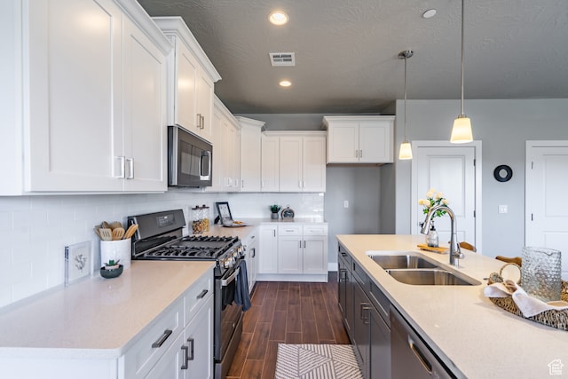 278 N 2020 W, Hurricane, UT 84737 - kitchen featuring sink, stainless steel appliances, pendant lighting, white cabinets, and dark hardwood / wood-style floors