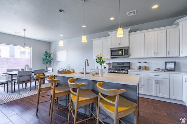 278 N 2020 W, Hurricane, UT 84737 - kitchen with stainless steel appliances, dark wood finished floors, light countertops, decorative backsplash, and recessed lighting