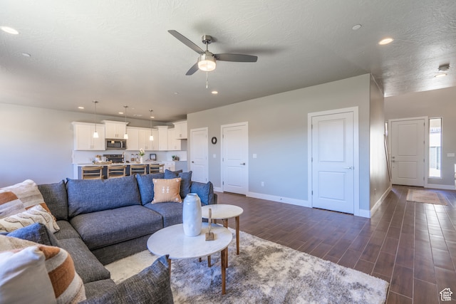 278 N 2020 W, Hurricane, UT 84737 - living room featuring dark wood-type flooring, ceiling fan, and a textured ceiling