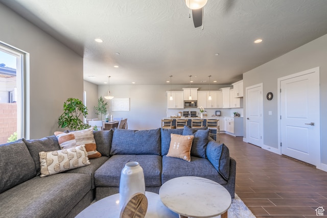 278 N 2020 W, Hurricane, UT 84737 - living room with a textured ceiling, dark wood-type flooring, and ceiling fan