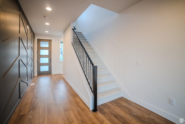 entryway with stairway, recessed lighting, baseboards, and light wood-style floors