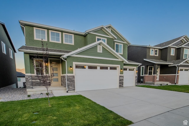 view of front of home featuring concrete driveway, stone siding, stucco siding, and a front lawn