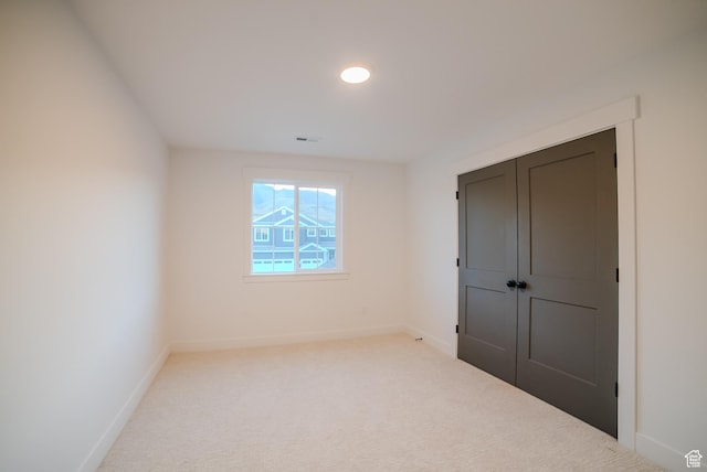 empty room featuring visible vents, baseboards, and carpet floors