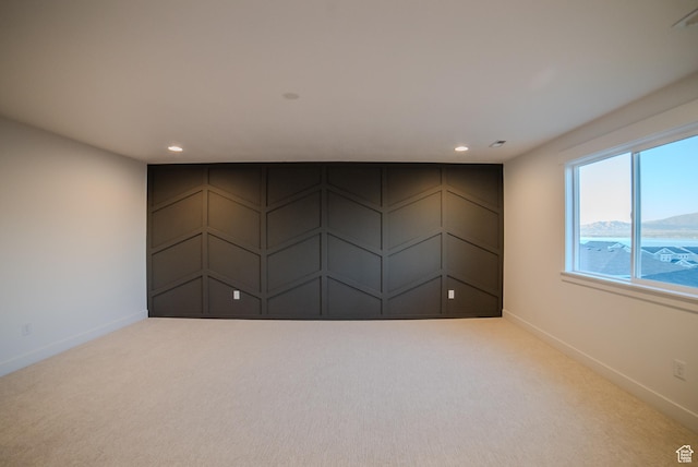 carpeted spare room with baseboards and recessed lighting