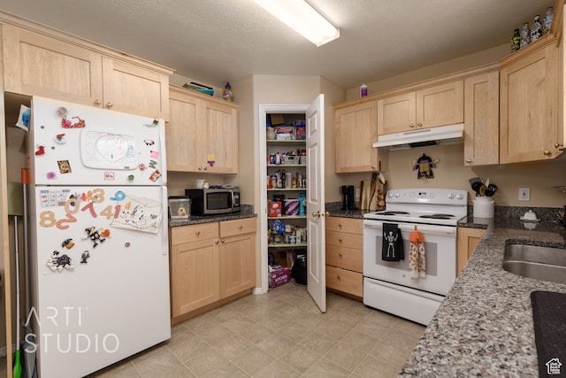 kitchen with white appliances, light brown cabinetry, sink, a textured ceiling, and dark stone counters