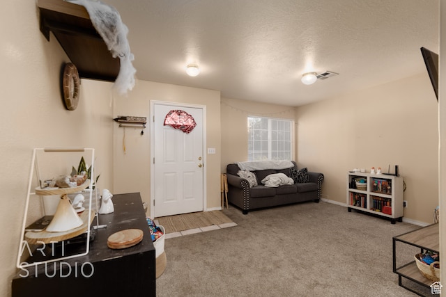 living room featuring a textured ceiling and carpet