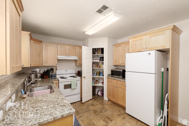 kitchen featuring sink, light brown cabinetry, light stone counters, a textured ceiling, and white appliances