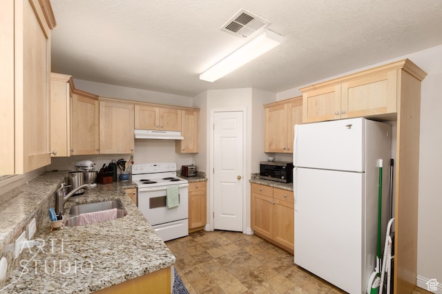 kitchen with light stone counters, a textured ceiling, light brown cabinetry, sink, and white appliances