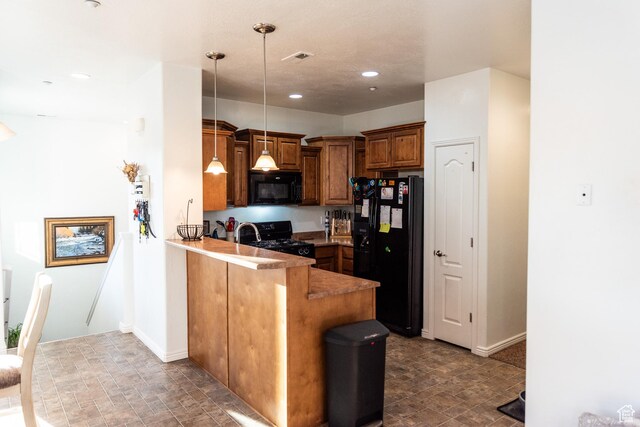 kitchen with hanging light fixtures, brown cabinetry, a peninsula, recessed lighting, and black appliances