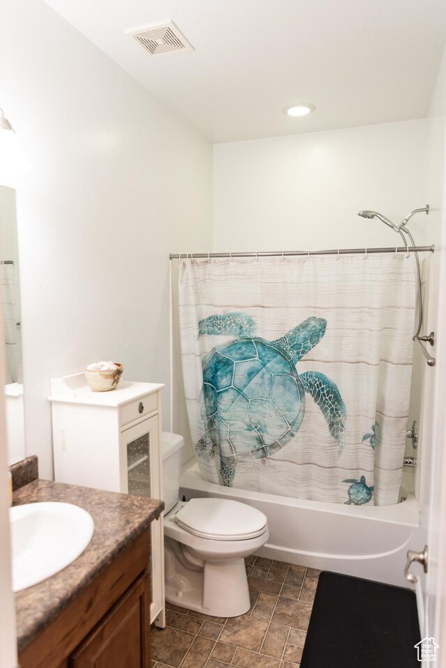 bathroom with vanity, shower / tub combo with curtain, toilet, stone finish flooring, and visible vents