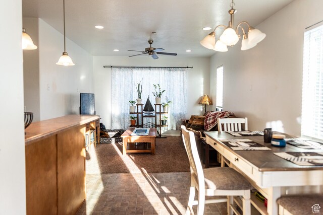 dining space with ceiling fan with notable chandelier and recessed lighting