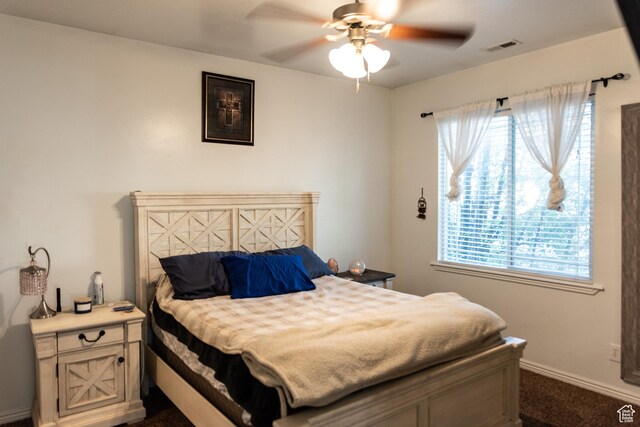 bedroom with baseboards, multiple windows, ceiling fan, and visible vents