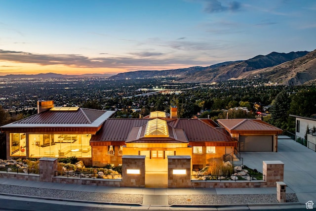 3809 E Thousand Oaks Cir, Salt Lake City, UT 84124 - view of front of property with a standing seam roof, a chimney, a mountain view, a metal roof, and concrete driveway