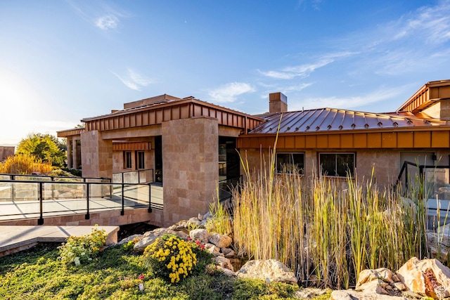 3809 E Thousand Oaks Cir, Salt Lake City, UT 84124 - view of side of home with a standing seam roof, a chimney, and a metal roof