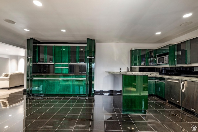 3809 E Thousand Oaks Cir, Salt Lake City, UT 84124 - kitchen featuring appliances with stainless steel finishes, recessed lighting, green cabinetry, dark tile patterned floors, and light stone countertops