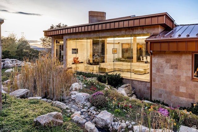 3809 E Thousand Oaks Cir, Salt Lake City, UT 84124 - view of side of home with a chimney, stone siding, and a standing seam roof