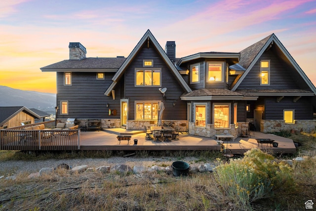 75 Hidden Oaks Ln, Park City, UT 84060 - rear view of house featuring outdoor dining space, a chimney, a wooden deck, and stone siding