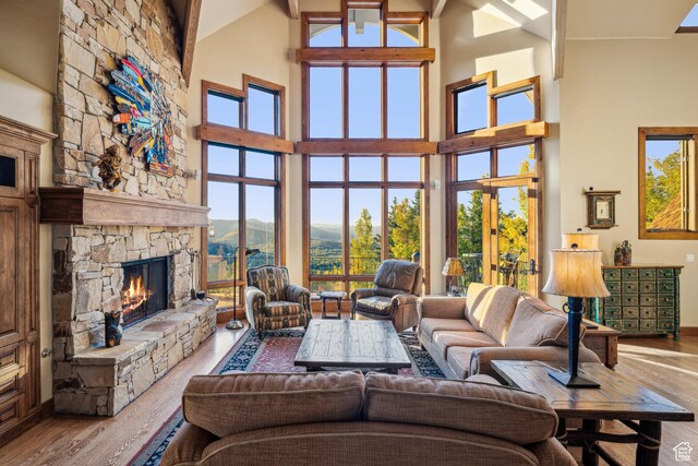 75 Hidden Oaks Ln, Park City, UT 84060 - living room with a mountain view, wood finished floors, a stone fireplace, and a high ceiling
