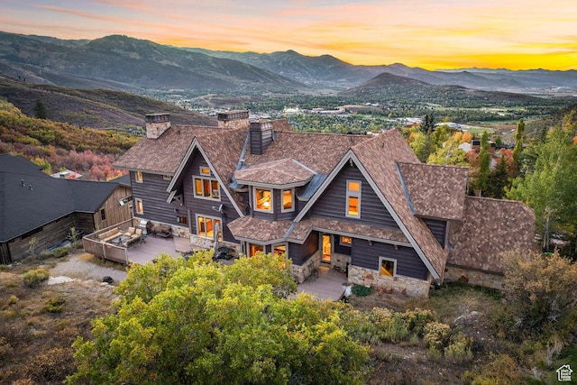 75 Hidden Oaks Ln, Park City, UT 84060 - back of property with a mountain view, stone siding, and a chimney
