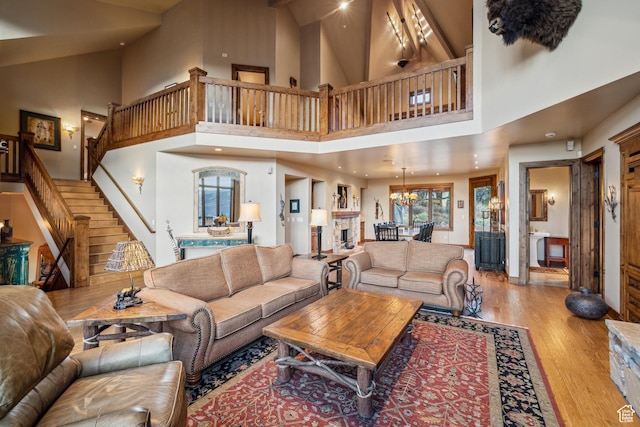 75 Hidden Oaks Ln, Park City, UT 84060 - living area featuring high vaulted ceiling, wood finished floors, an inviting chandelier, and stairs